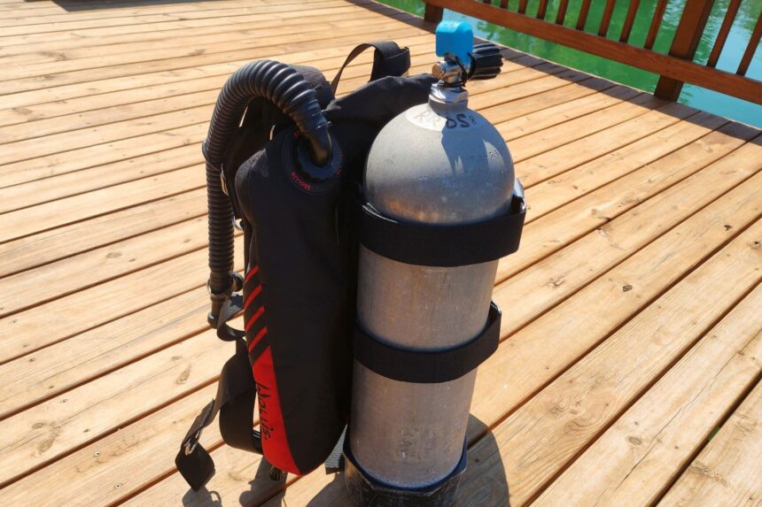 Hollis STS wing with corrugated inflator hose mounted on a tank, seen from the shoulder side