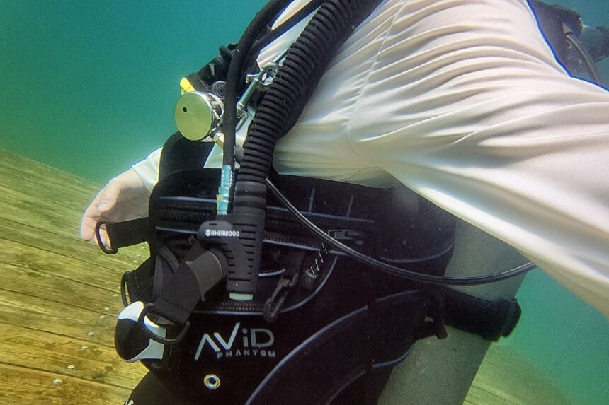 Side view of our tester underwater in the Sherwood Avid Phantom with the power inflator in hand