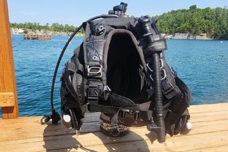 Sherwood Avid Phantom BCD with weight pockets and inflator hose set up on a dock for DIVEIN testing