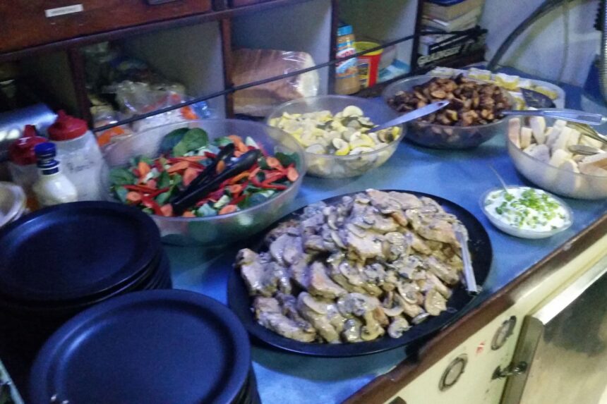 Salads and side dishes arranged on the galley counter