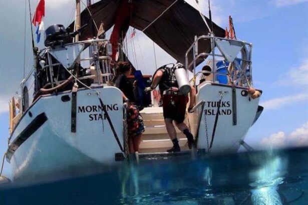 Diver stepping off the stern dive platform of Blackbeard's Morning Star