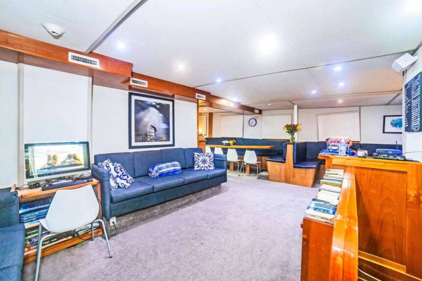 Blue sofa lounge area aboard a liveaboard yacht
