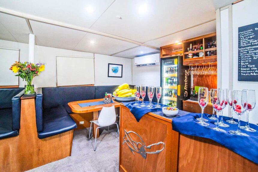 Cozy wood-paneled bunk cabin with reading lights aboard the Nautilus UnderSea