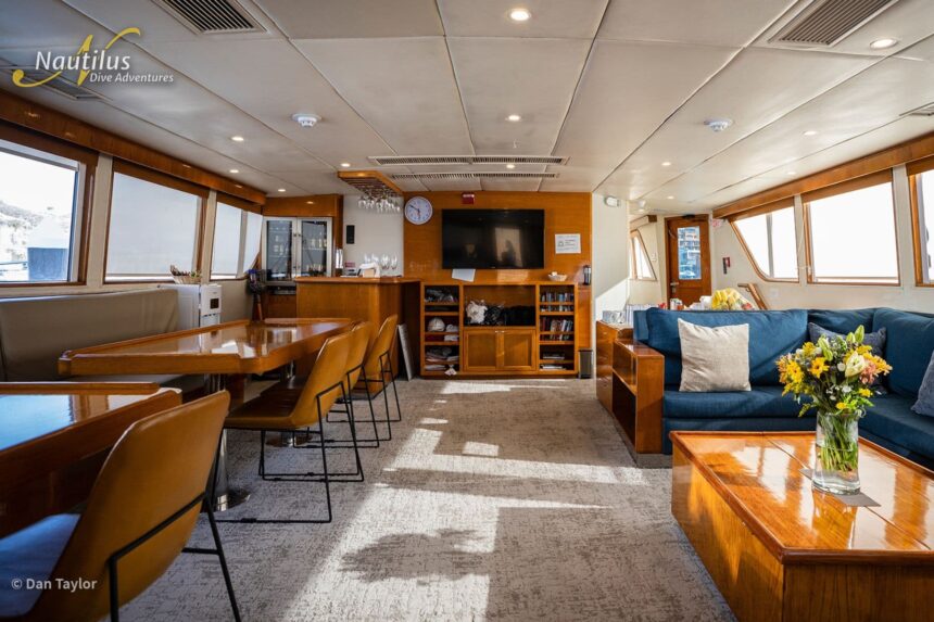 Dining and lounge area with a stocked bar aboard the Nautilus Gallant Lady