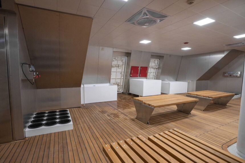Empty spa style deck room with white benches aboard the M/Y White Pearl