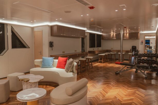Lounge and gym corner onboard the White Pearl with a curved sofa, bar seating, and weight equipment
