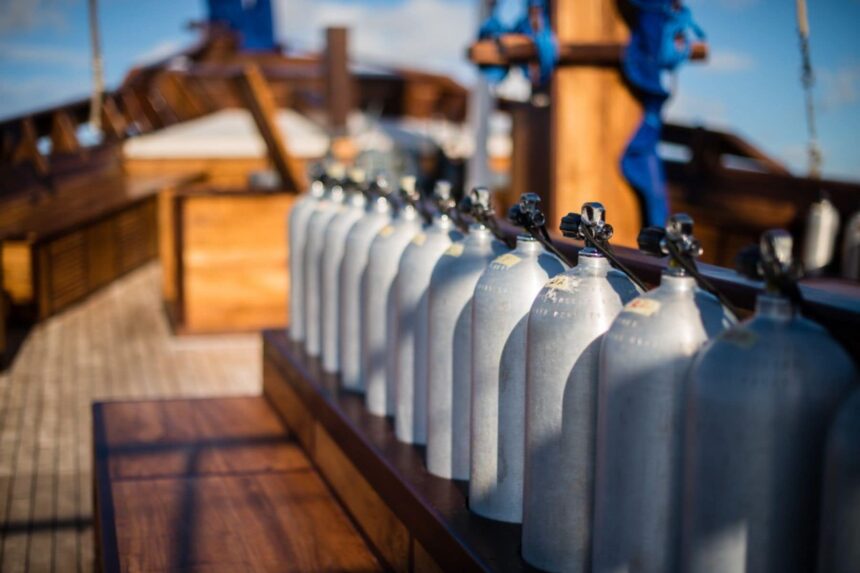 Row of scuba tanks lined up on the Samambaia liveaboard's dive deck
