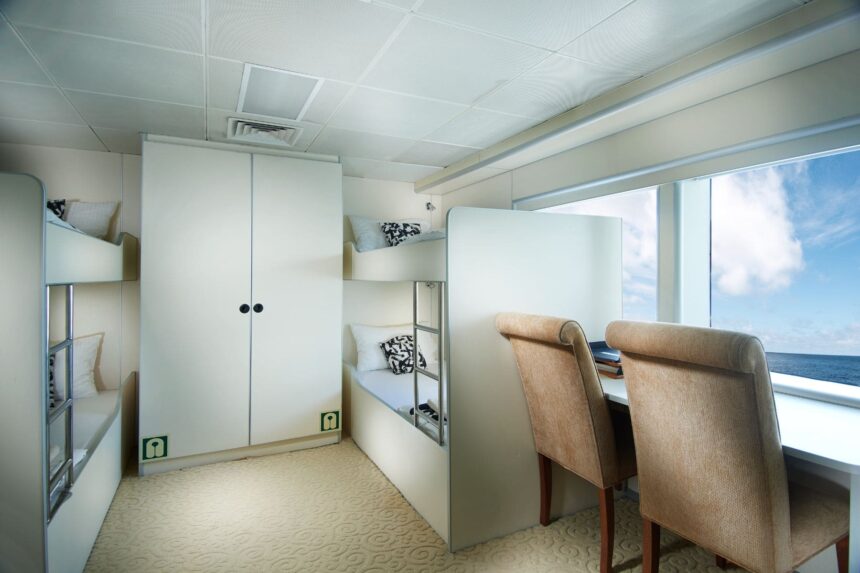 Bunk cabin with desk and chairs aboard the Solitude Adventurer