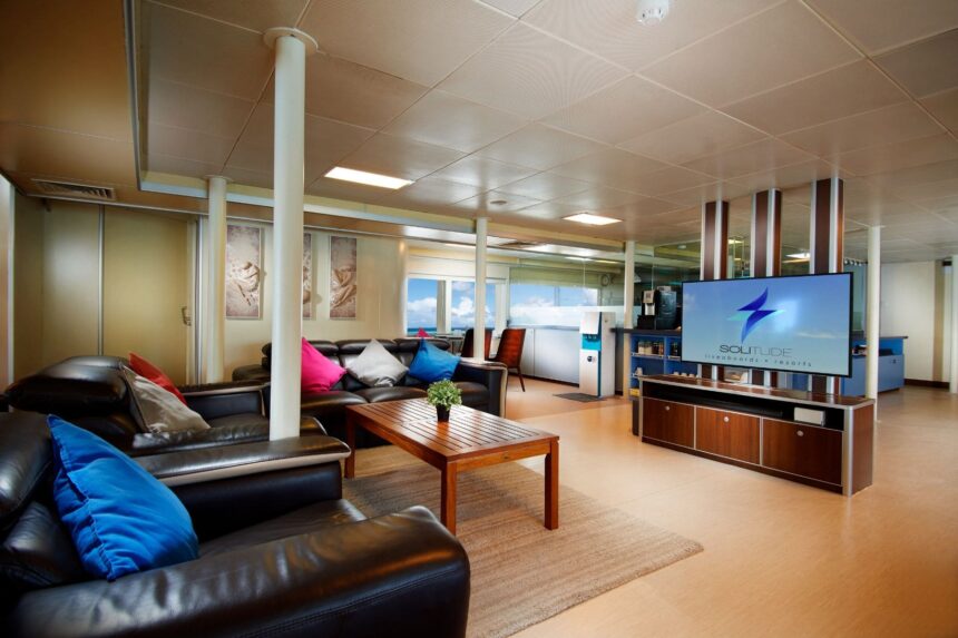 Lounge area with leather sofas and TV screen aboard the Solitude Adventurer