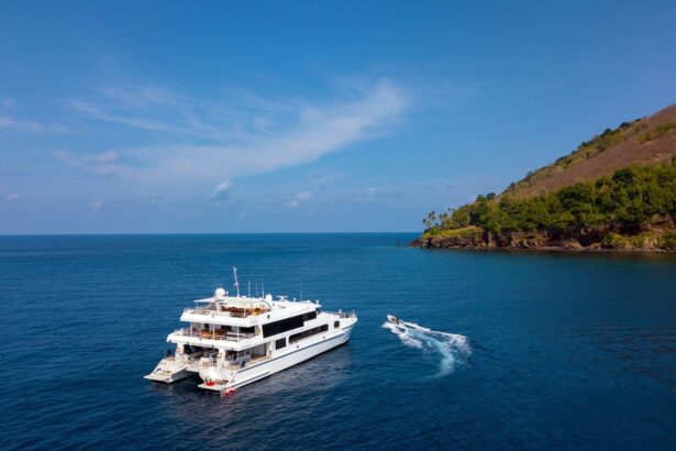 The Solitude Adventurer catamaran cruising near a tropical coastline