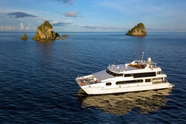 The Solitude Adventurer catamaran anchored near rocky islets at sunset