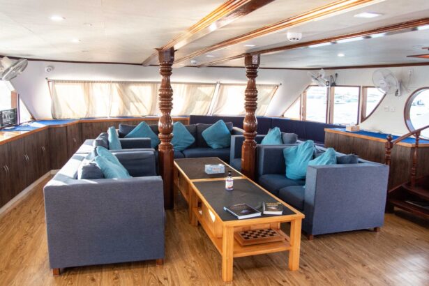 An outdoor dining table set for guests on the upper deck of the Emperor Voyager