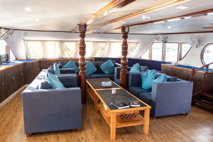 An outdoor dining table set for guests on the upper deck of the Emperor Voyager