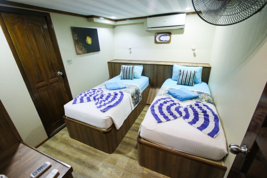 A cozy lounge area aboard the Emperor Voyager with blue sofas and a games table