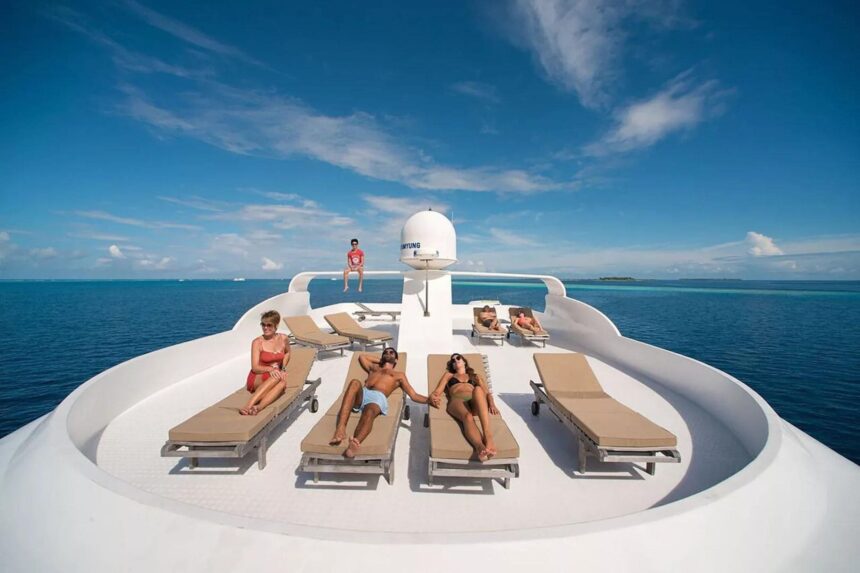 A covered seating area with wooden chairs and a small bar aboard the Emperor Virgo