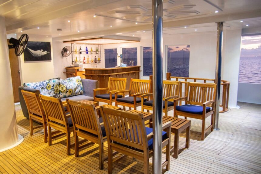Guests enjoy dinner together at a long table aboard the Emperor Virgo
