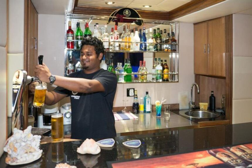 An outdoor bar and sun loungers on the upper deck of the Emperor Virgo