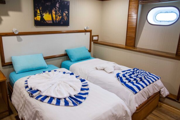 Twin beds with striped towels in a cabin aboard the Emperor Virgo