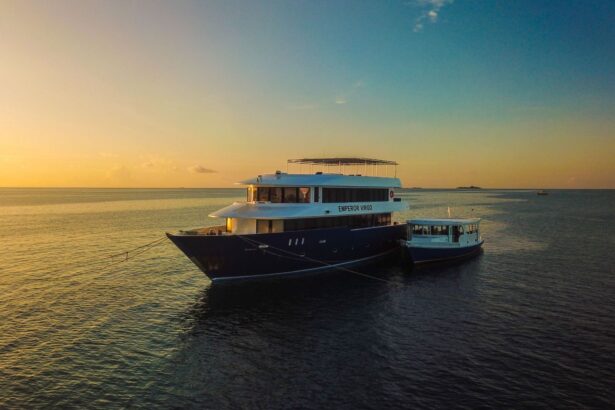 The Emperor Virgo liveaboard and tender boat at anchor during sunset