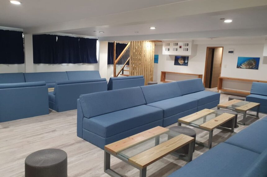 Blue sofa seating and coffee tables in the All Star Avalon's lower salon