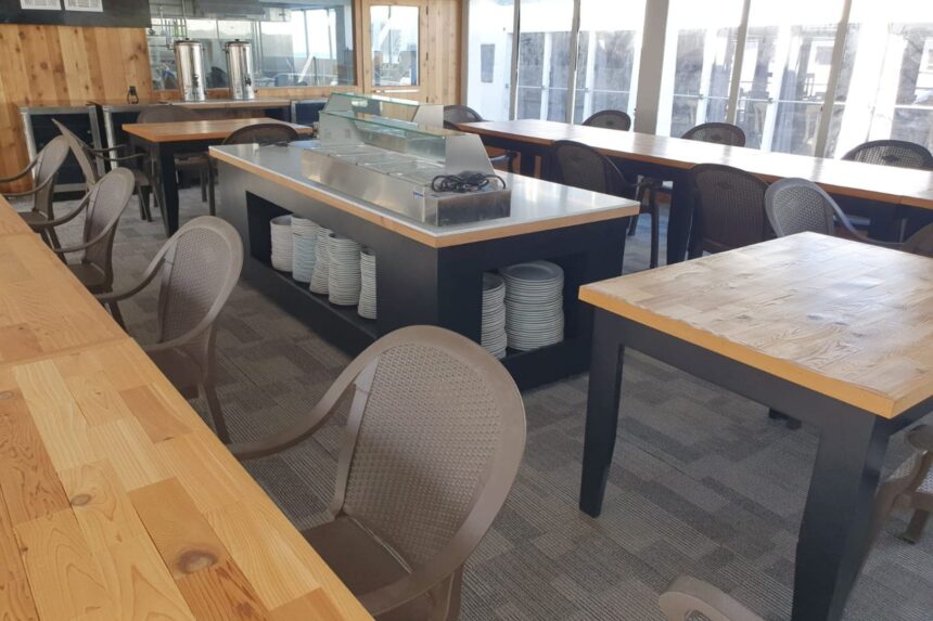 Buffet counter with stacked plates in the All Star Avalon's dining room