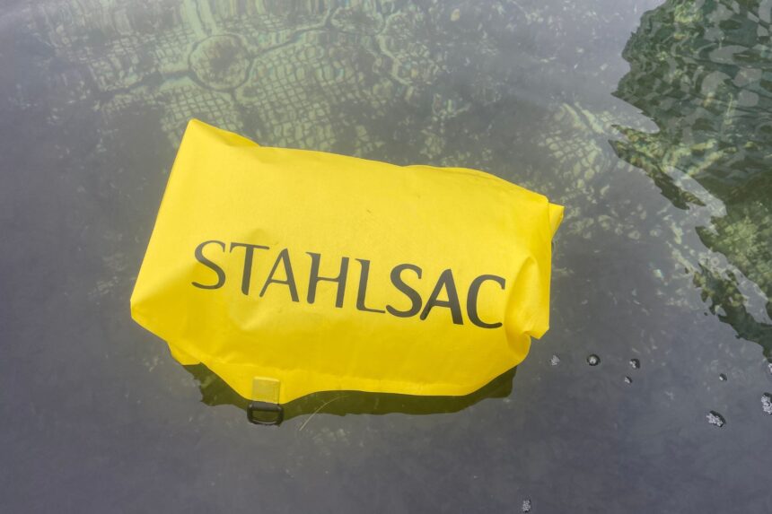 Yellow Stahlsac dry bag floating on the water surface