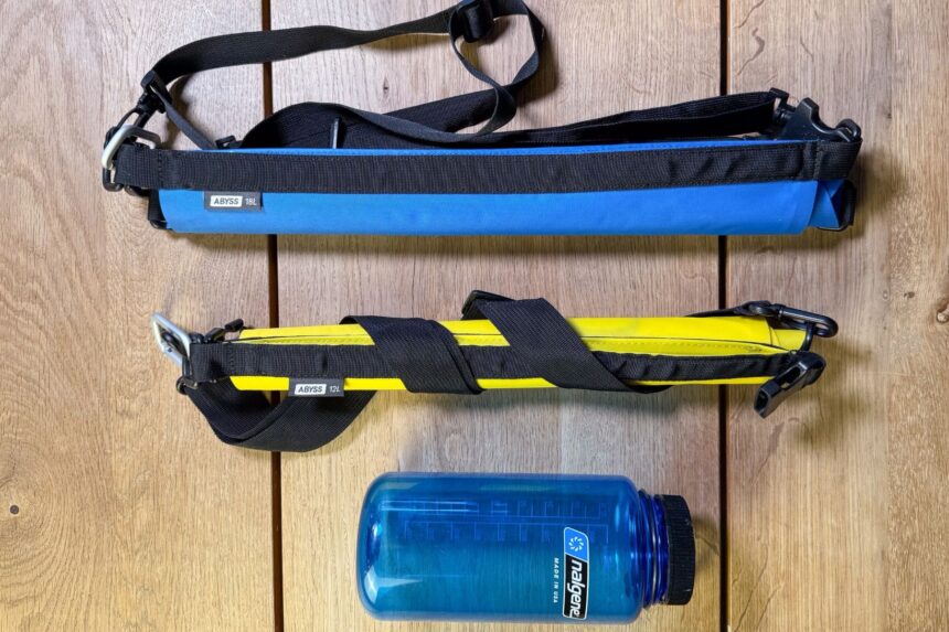 Drylite Dry Bags Packed Down Two Stahlsac Drylite dry bags rolled down beside a water bottle to show how small they pack