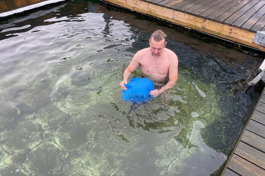 Stahlsac DryLite Water Test Man testing the Stahlsac DryLite dry bag by submerging it in a pool