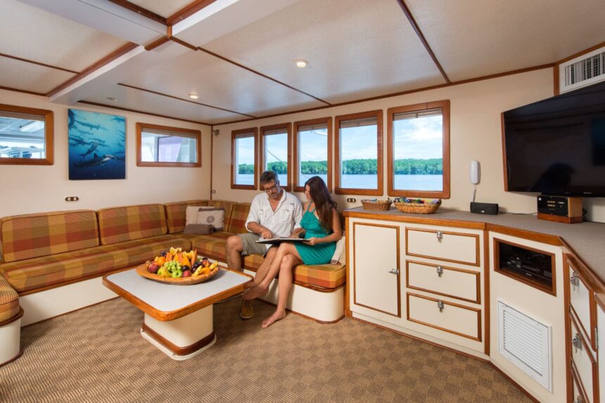 A couple looks over dive logs together in the Sea Hunter's salon lounge