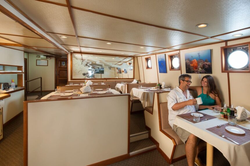 A couple shares coffee at a window table in the Sea Hunter's dining room