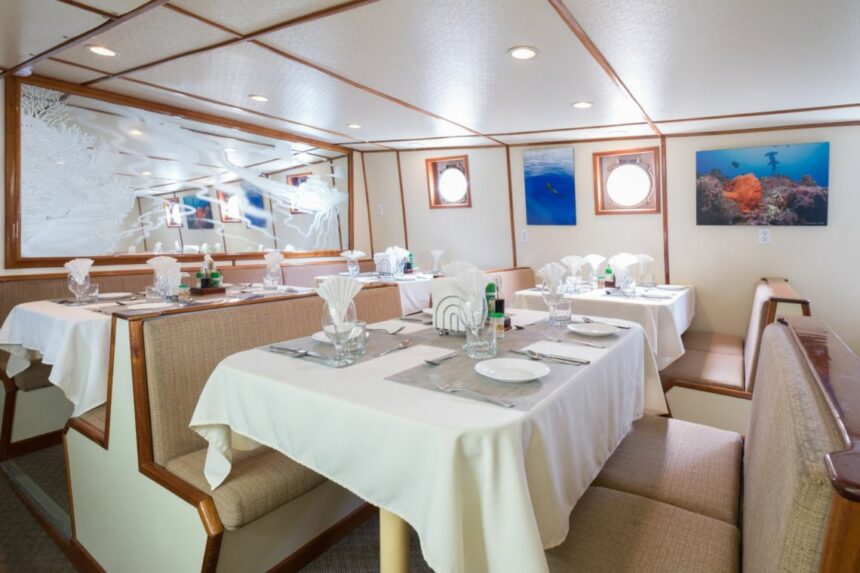 Tables set for dinner in the Sea Hunter's booth-style dining room