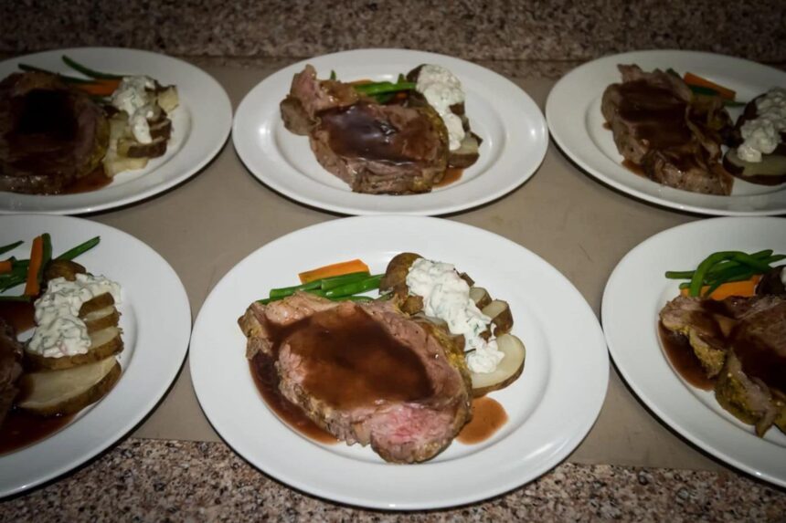 Plated roast beef dinners with vegetables and potatoes ready to serve