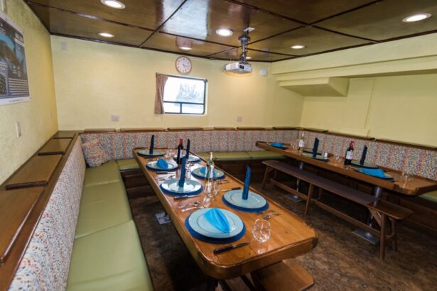 Tables set for dinner with blue napkins in the Quino El Guardian's dining salon
