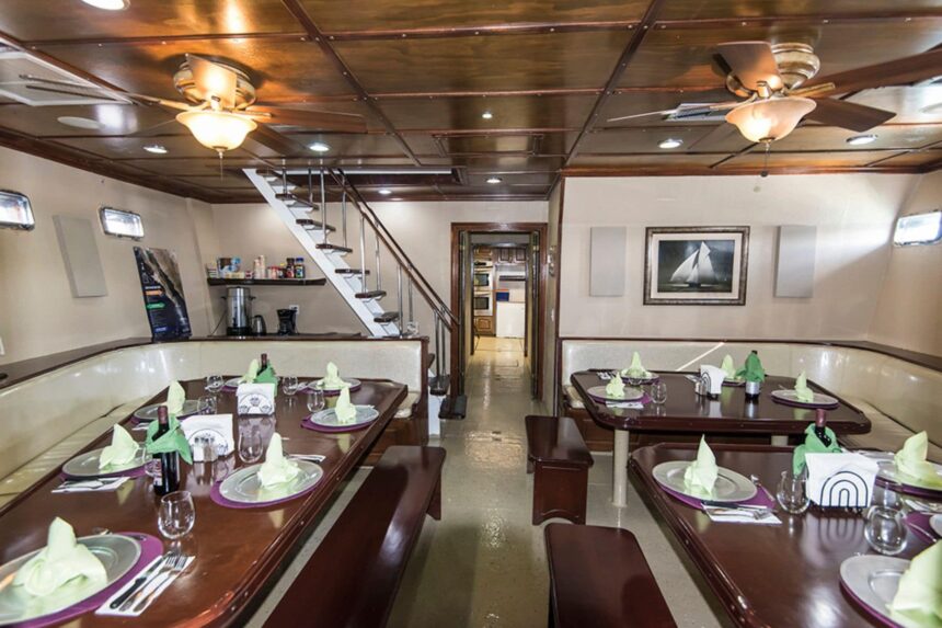 Dining salon aboard the Rocio del Mar set with tables and place settings