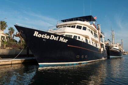 Rocio del Mar liveaboard docked in harbor beside another dive boat