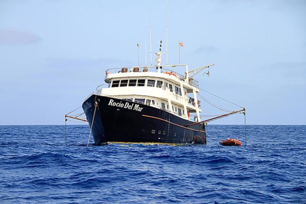 The Rocio del Mar liveaboard anchored at sea with its tender alongside