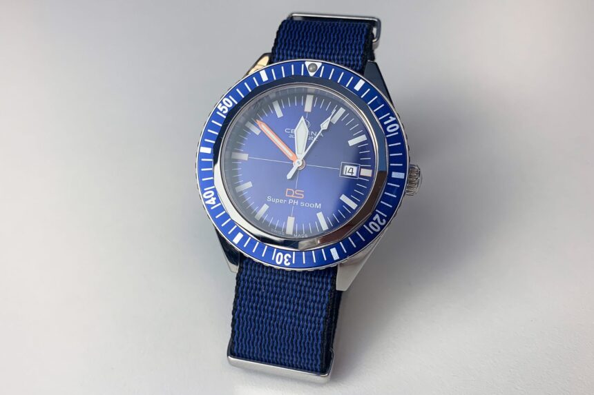Certina PH500M Dial And Bezel Front view of the Certina DS Super PH500M dial with blue bezel, orange minute hand and date window