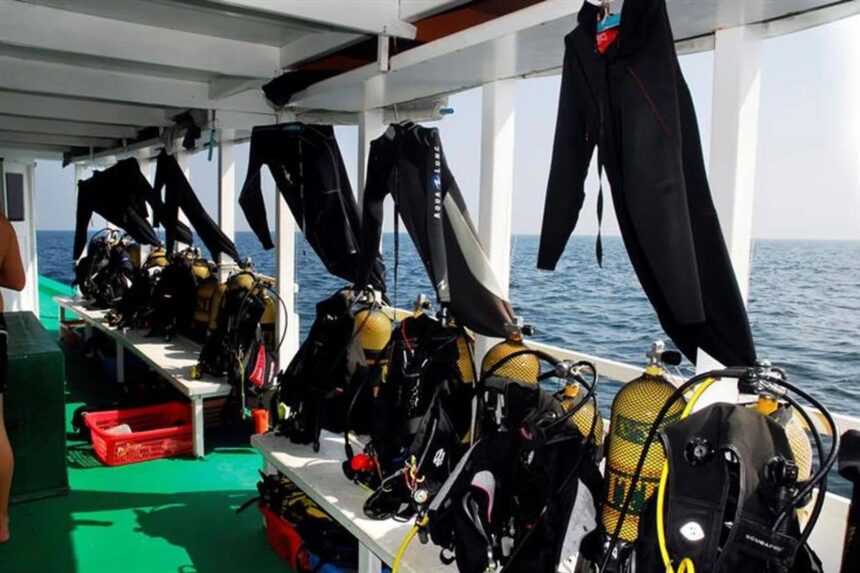 Wetsuits and dive gear hanging to dry on the dive deck of a Maldives liveaboard