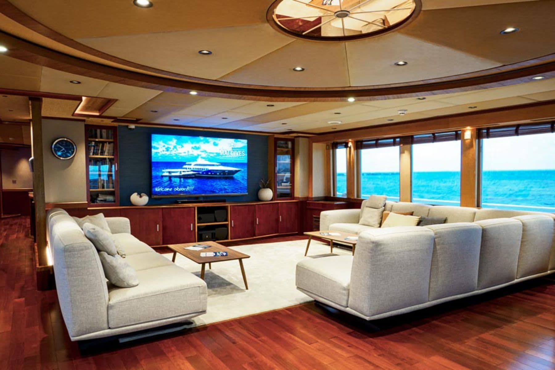 Living room aboard the Maldives Blue Force One with sofas facing a wall-mounted TV