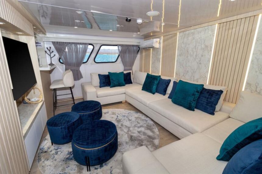 Shaded outdoor lounge seating with green cushions on the Galaxy Diver's deck