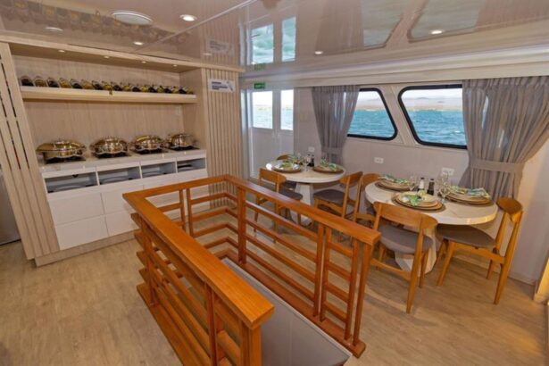 Covered upper deck lounge with white cushions and a red life ring on the Galaxy Diver