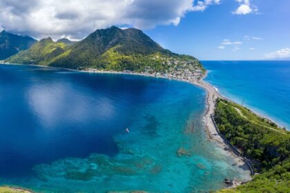 Aerial view of Soufriere Scotts Head Marine Reserve in Dominica, with a reef-fringed bay and green mountains