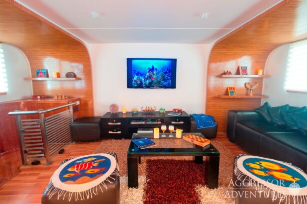 Living room with a wall mounted TV and leather sofas aboard the Red Sea Aggressor II