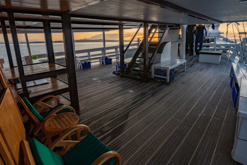 Wooden dive deck and staircase aboard the Pindito liveaboard at sunset