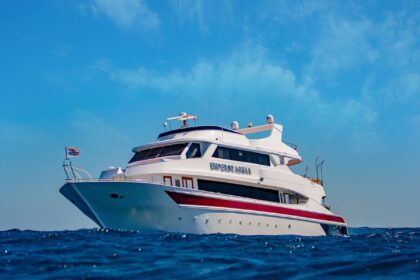 Emperor Asmaa liveaboard yacht at anchor under a blue sky