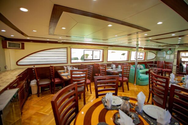 Dining area aboard the Emperor Asmaa set with wooden chairs and table settings
