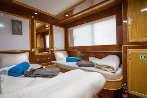 Twin cabin aboard the Emperor Asmaa with wood paneling and folded towels