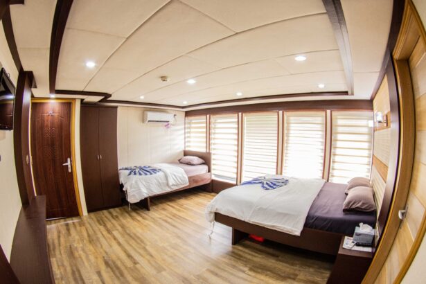 Twin cabin aboard the Emperor Serenity with wardrobe and striped towels