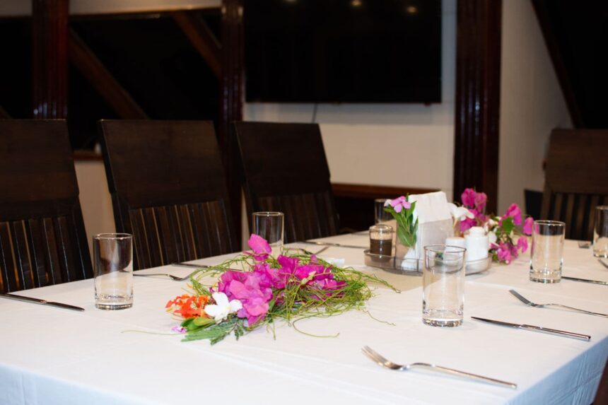 Dining table aboard the Emperor Leo set with glassware and a flower centerpiece
