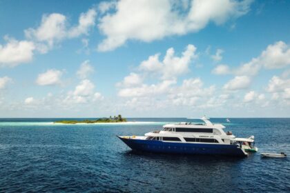 Emperor Leo liveaboard yacht anchored near a small sandbar island
